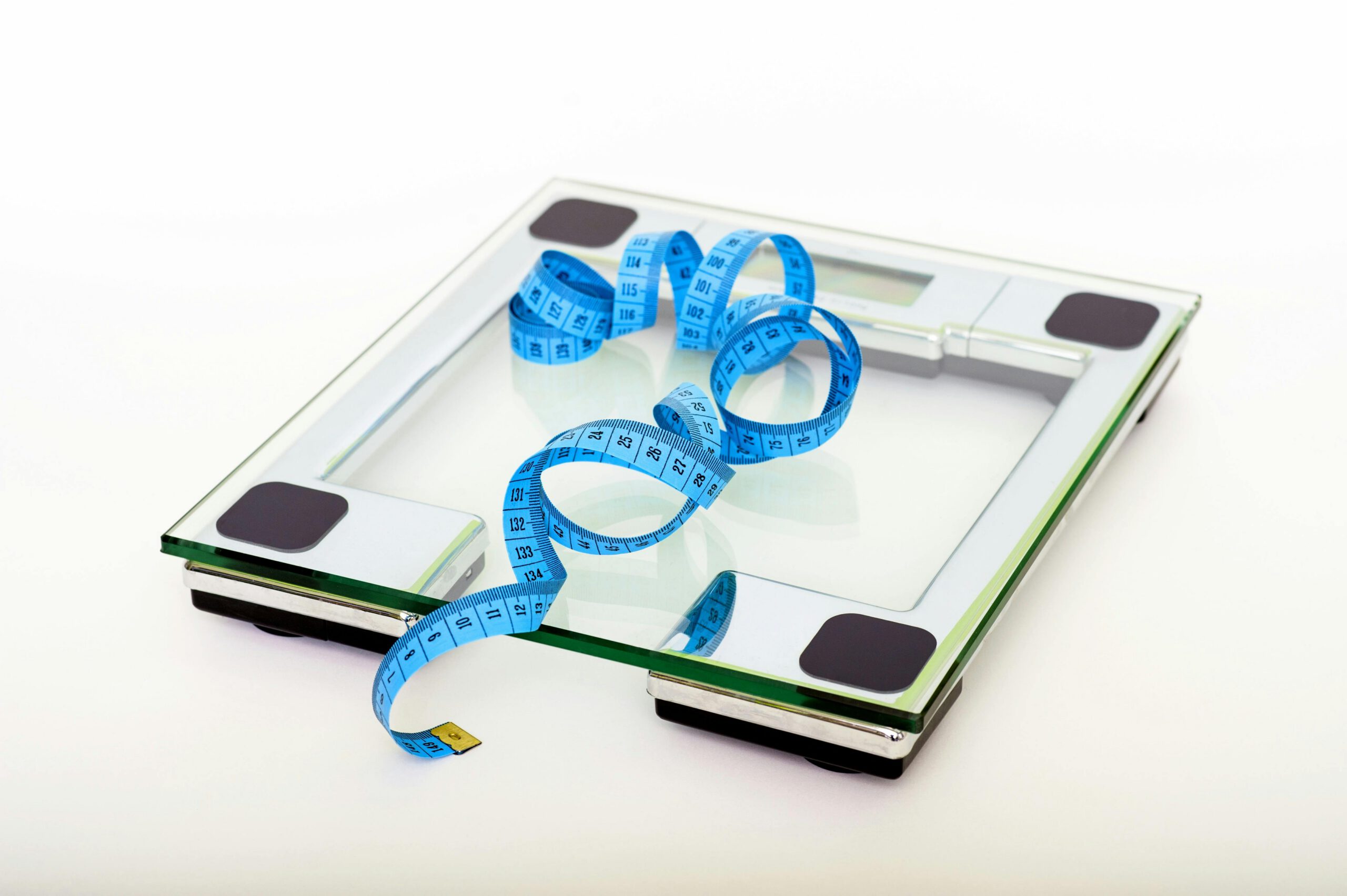 Picture of a scale with measuring ribbon on top of it.